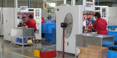 Skilled technicians operating semi-automated filter assembly stations at NewLine Filters production facility.